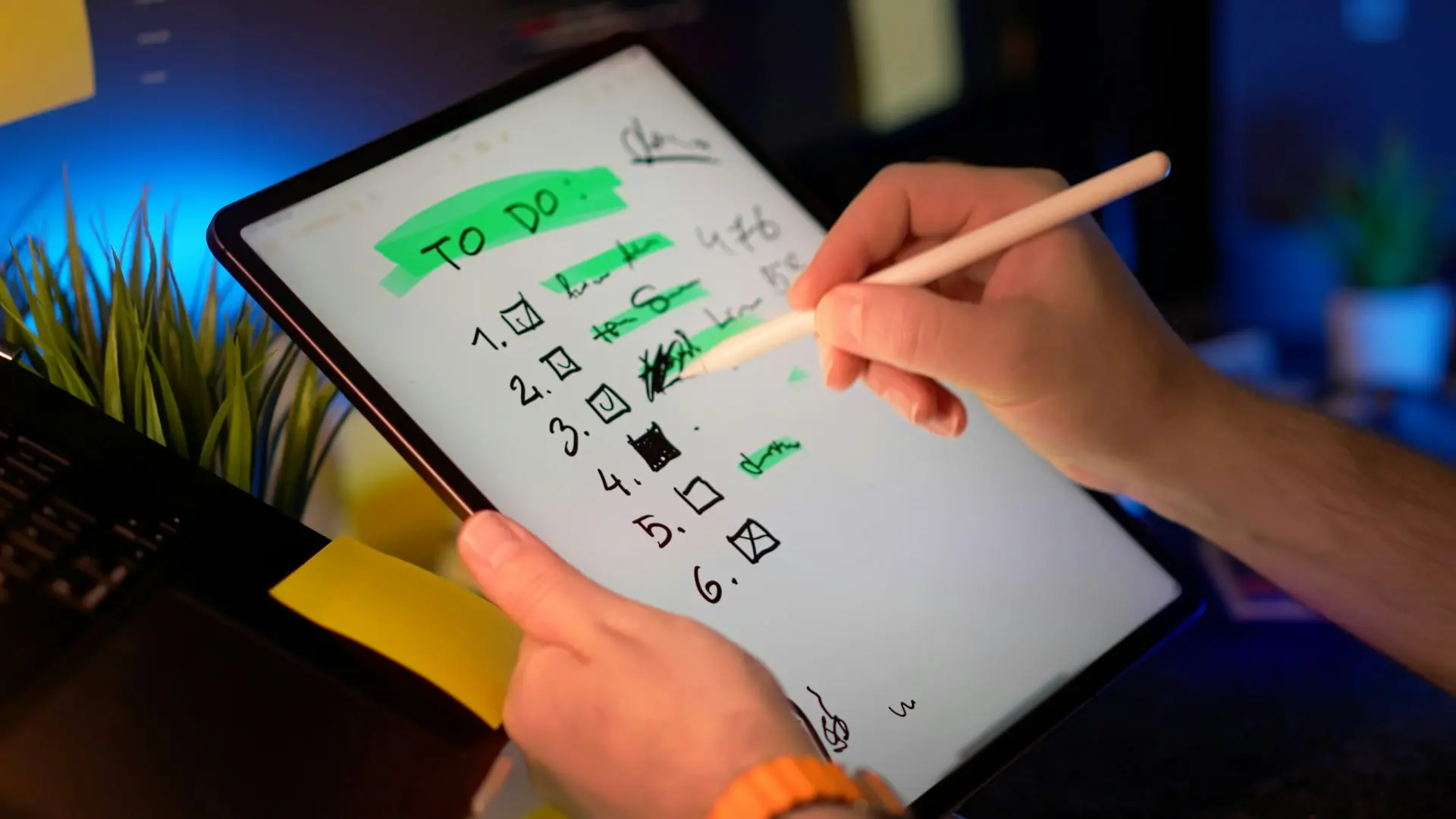 Person using stylus on tablet to check off to-do list.